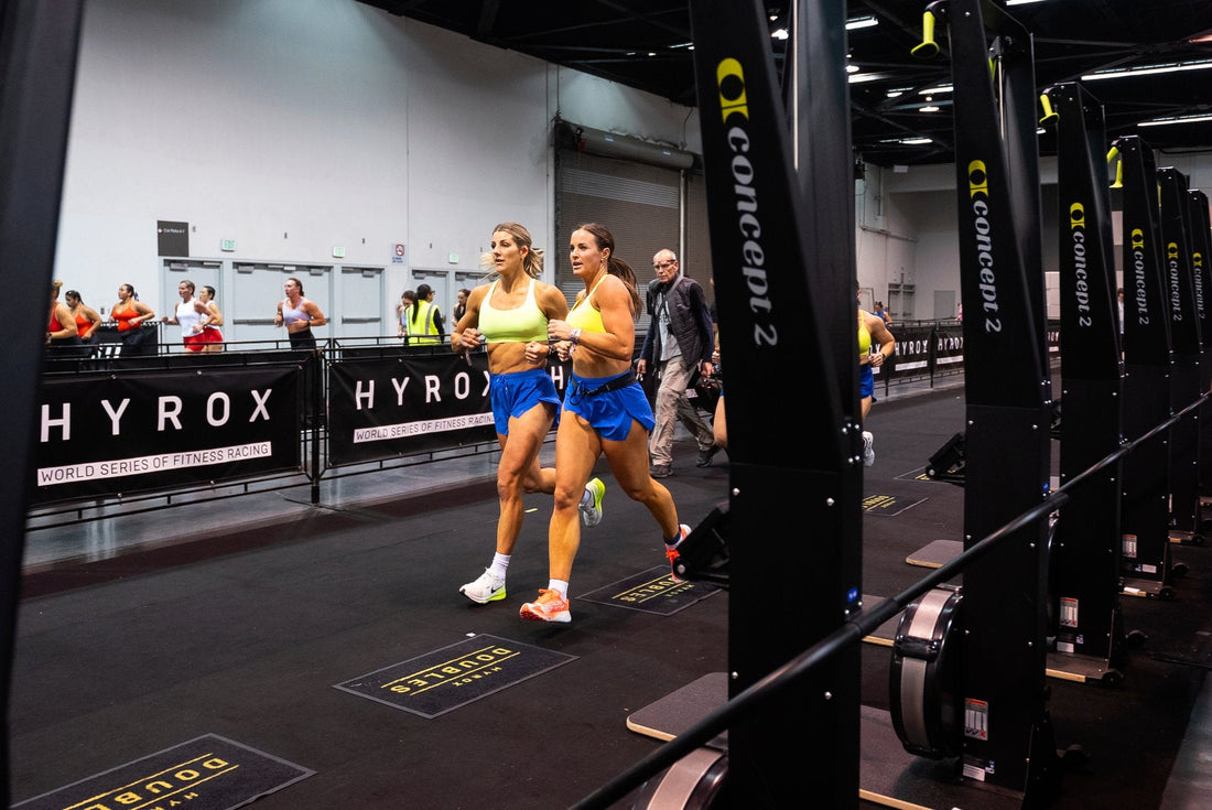 HYROX doubles partners running together through the competition arena