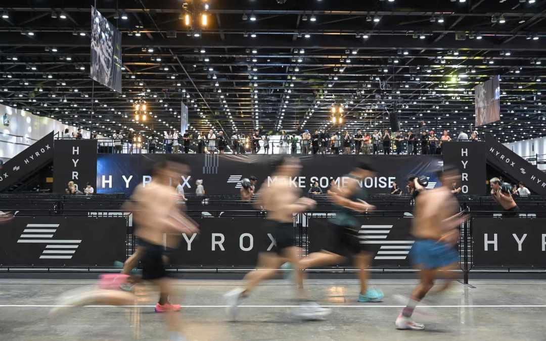 HYROX athlete moving through the race floor during a hybrid fitness event