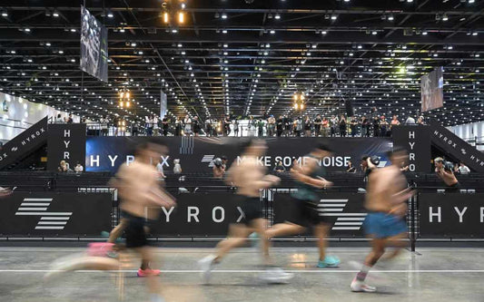 HYROX athlete moving through the race floor during a hybrid fitness event