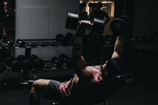 Lifter performing an incline dumbbell press for upper-chest growth