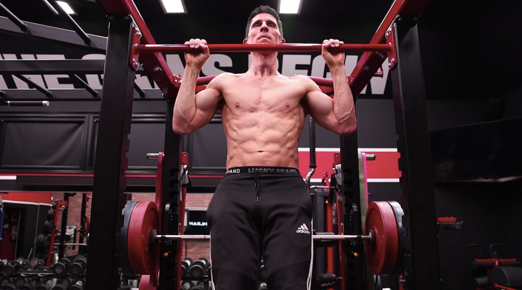 Jeff Cavaliere performing a pull-up in the ATHLEAN-X gym