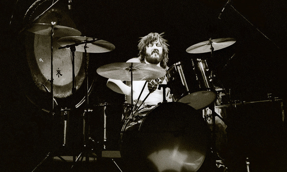 John Bonham performing behind his drum kit during a Led Zeppelin concert