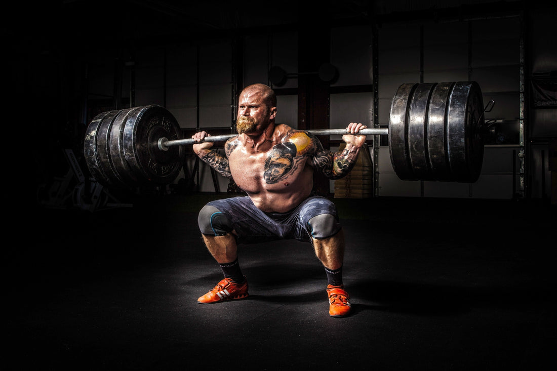 Powerful athlete performing a heavy barbell squat for a Justice League inspired workout