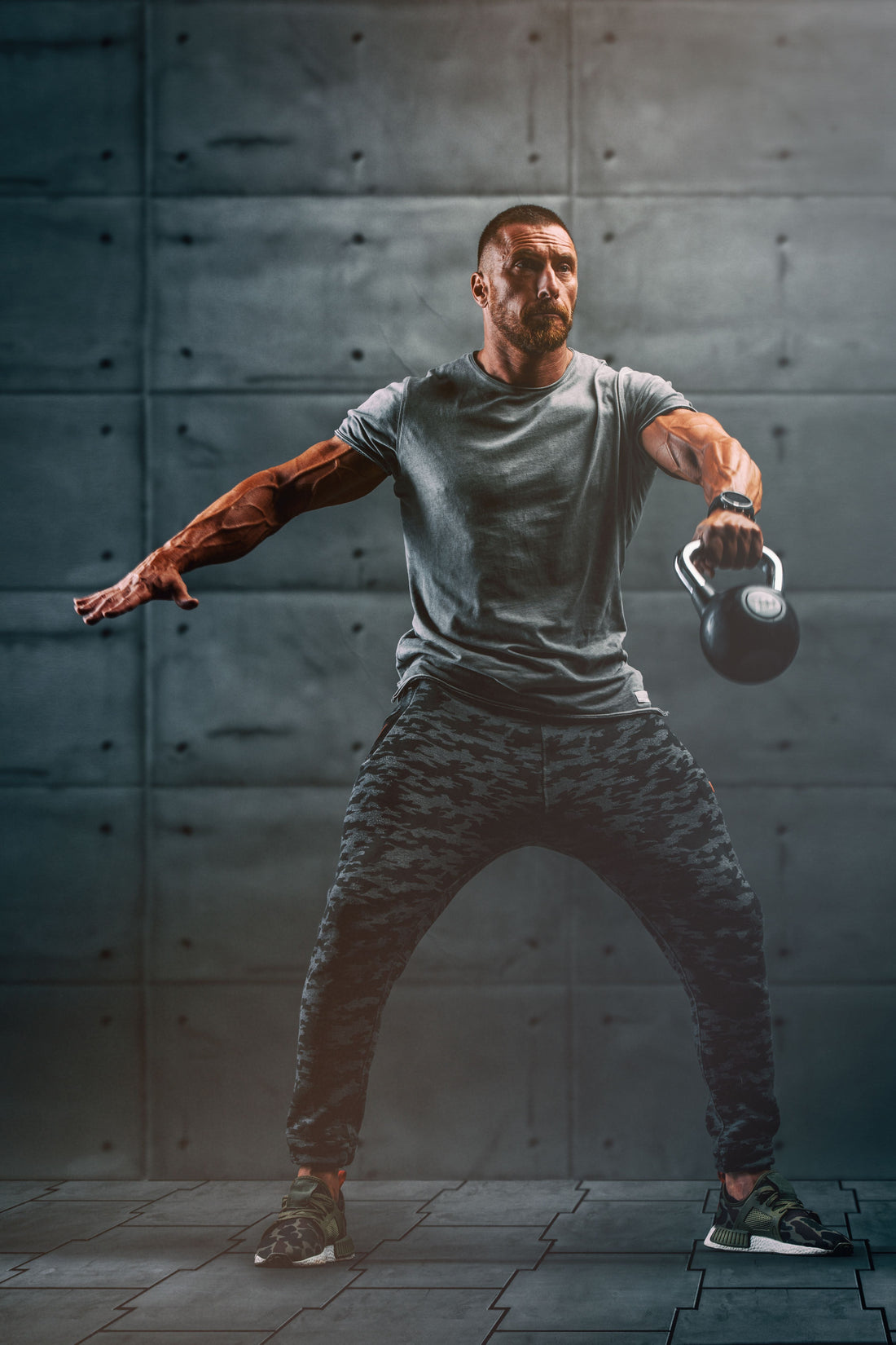 Athlete performing a powerful one-arm kettlebell snatch