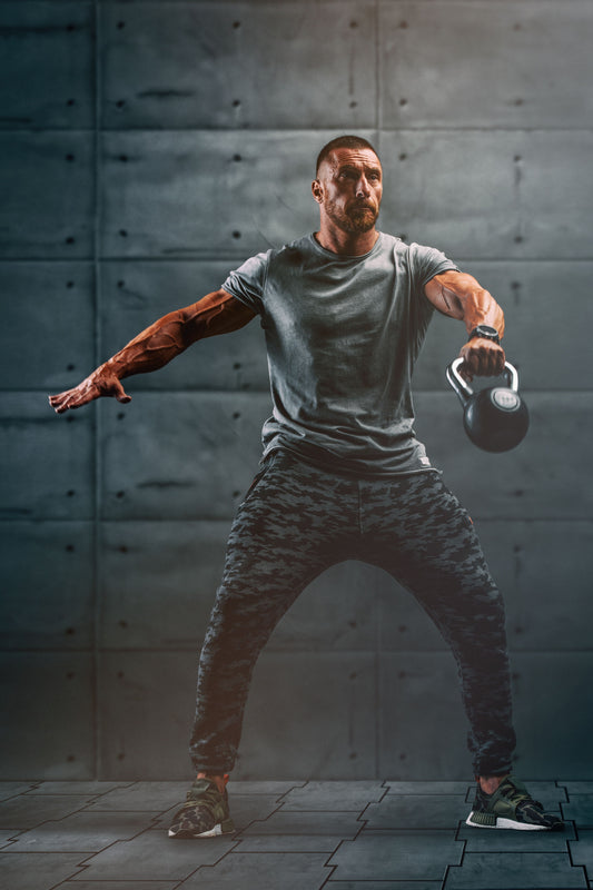 Athlete performing a powerful one-arm kettlebell snatch