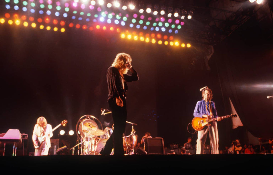 Led Zeppelin performing live under dramatic stage lights during a high-energy rock concert