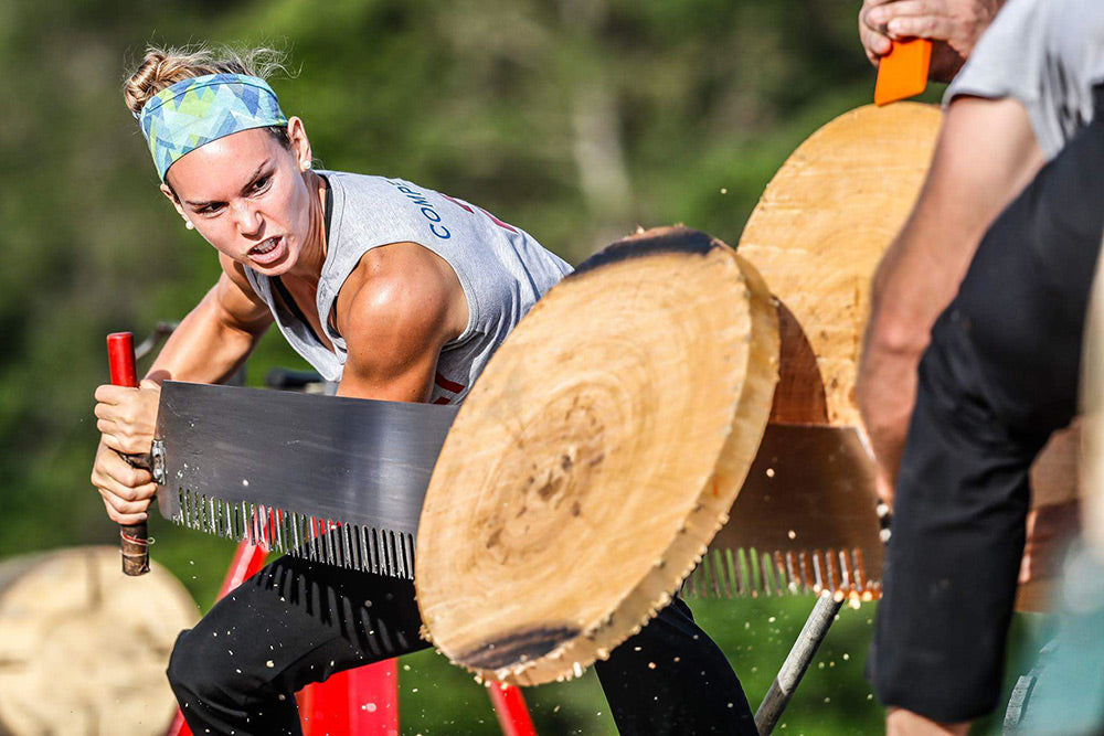 Martha King competing with a crosscut saw in a lumberjack event