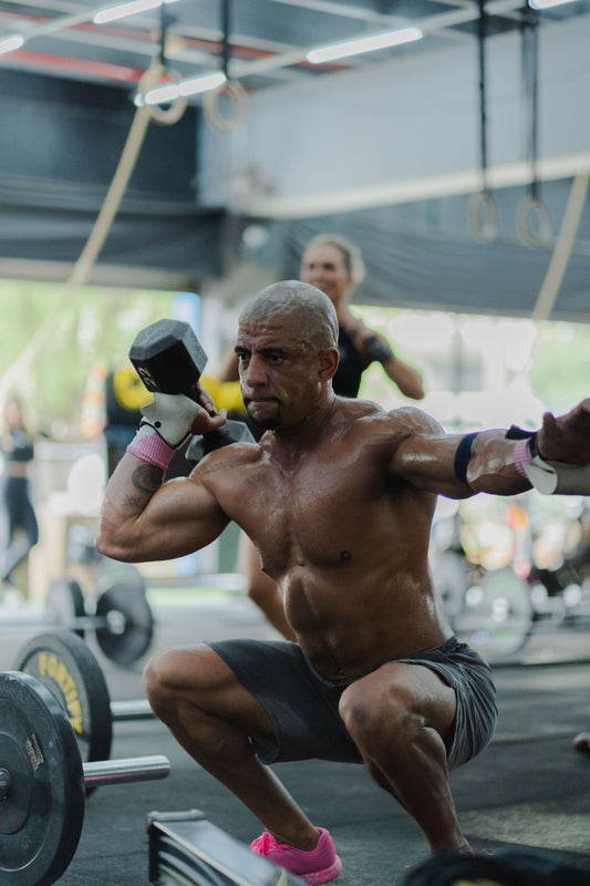 Athlete performing a focused dumbbell squat during a short strength workout