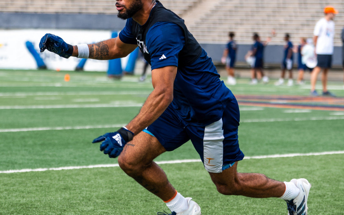 Football athlete accelerating through a cone drill on an outdoor field