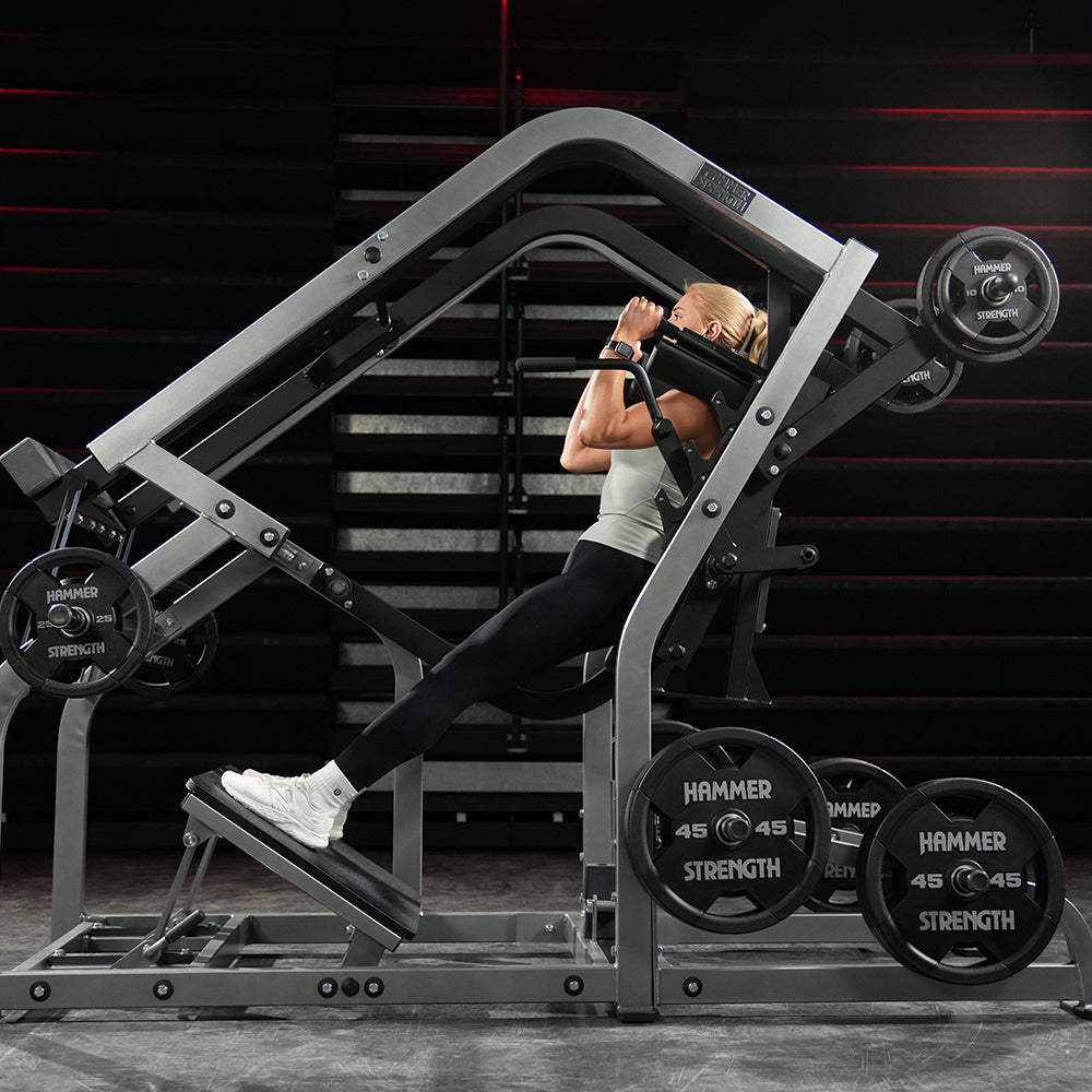 Athlete performing a plate-loaded pendulum squat