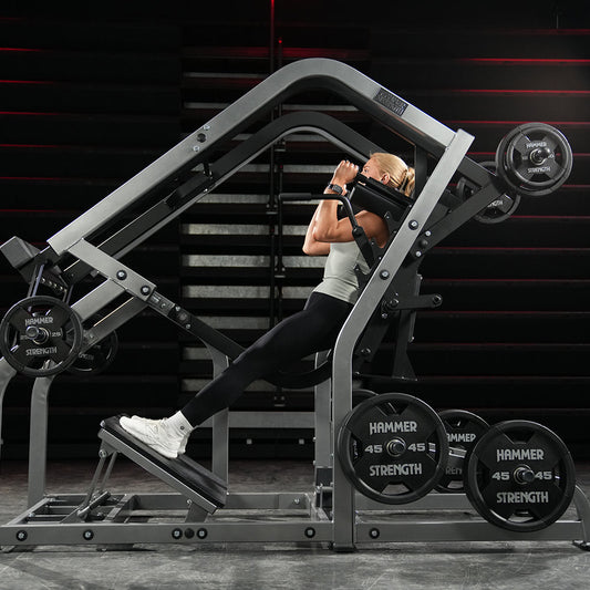 Athlete performing a plate-loaded pendulum squat