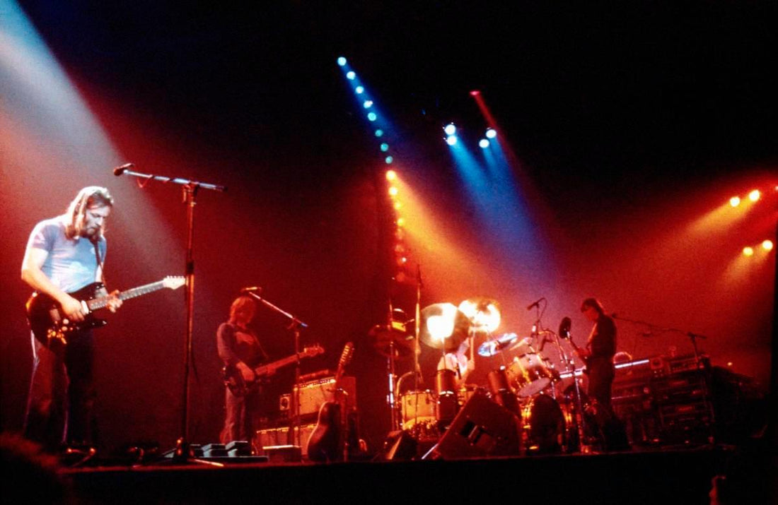 Pink Floyd performing live under dramatic stage lighting