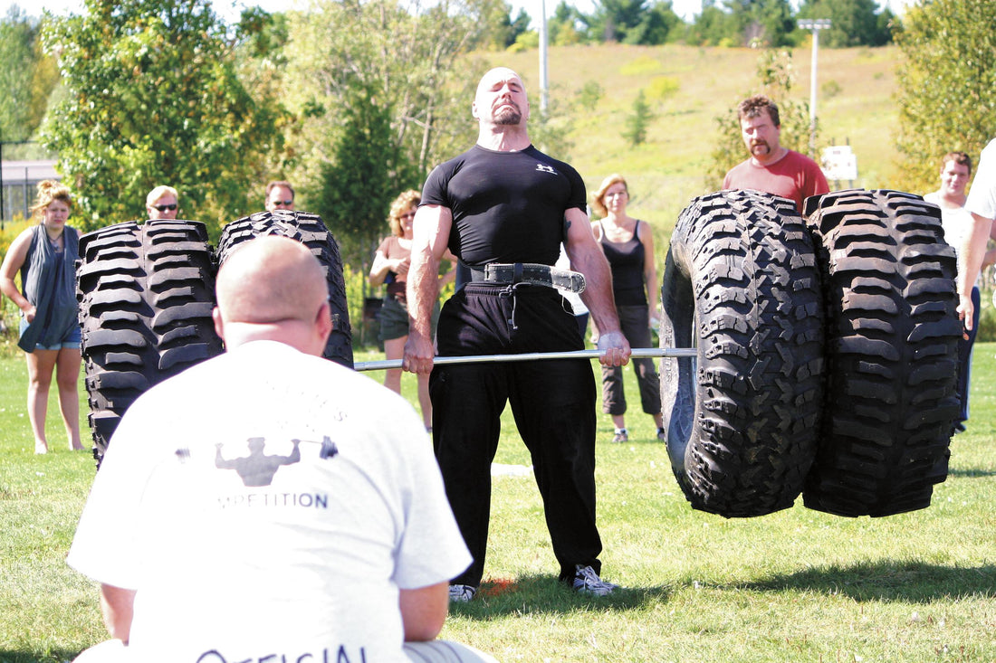 Strongman athlete deadlifting at a strength competition