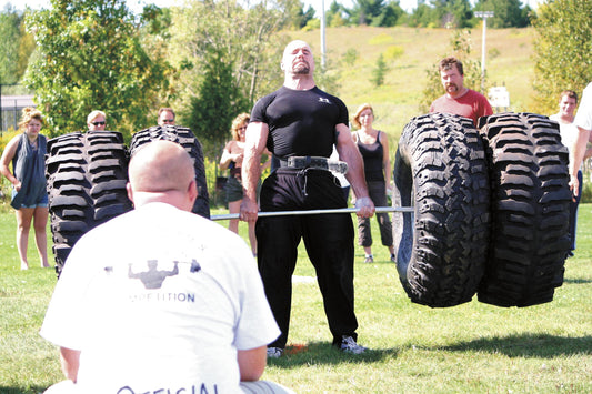 Strongman athlete deadlifting at a strength competition