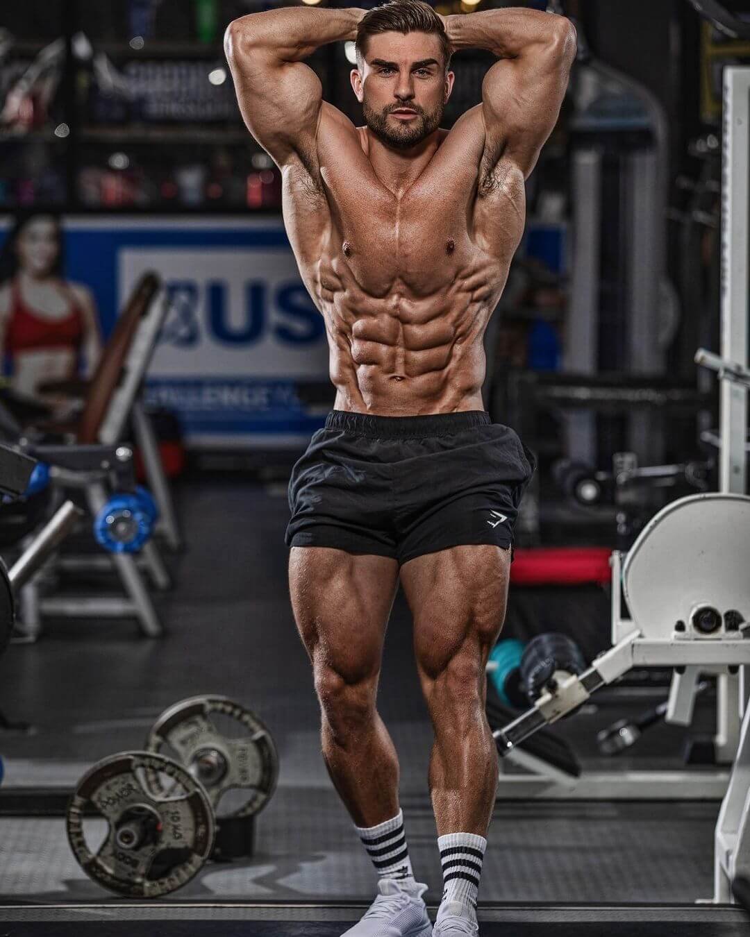 Ryan Terry showing his muscular physique and developed legs in a gym