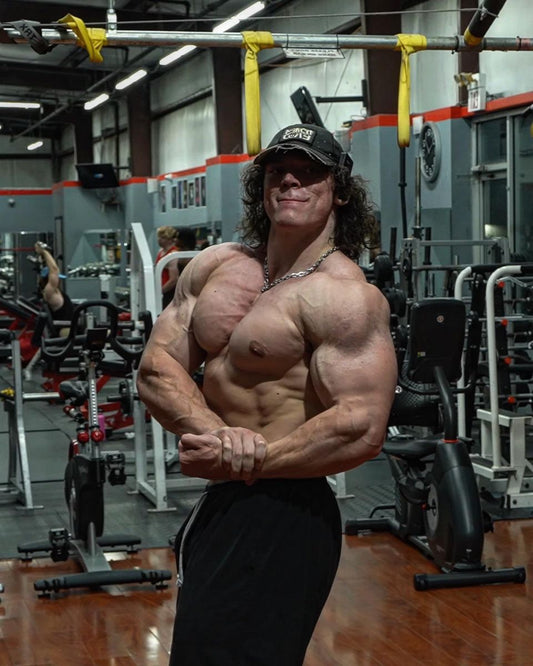 Sam Sulek posing in the gym during a discussion of bodybuilding diet and muscle gain