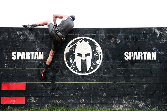 Athlete climbing a Spartan Race obstacle wall