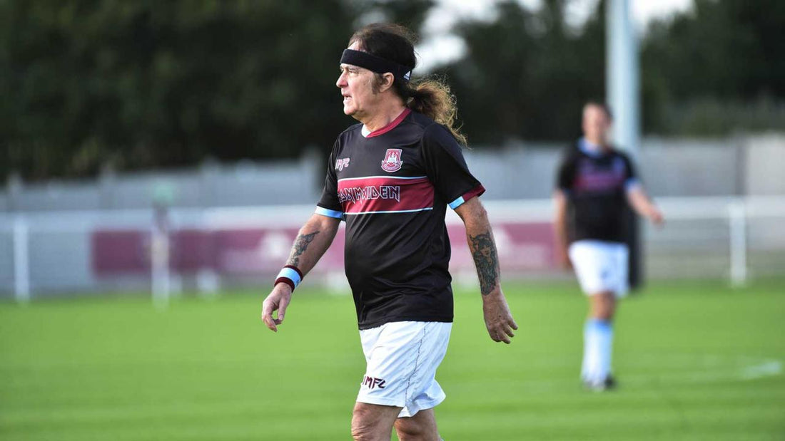 Steve Harris on a football pitch in an Iron Maiden kit