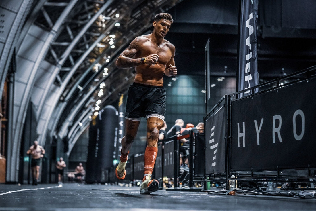 HYROX athlete running under fatigue during hybrid fitness competition