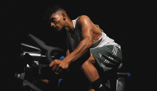 Athlete pushing hard on a stationary bike during high-intensity interval training
