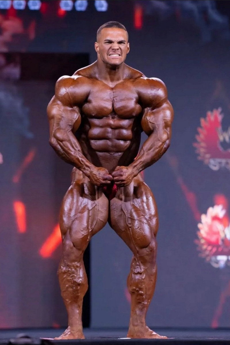 Nick Walker posing onstage after winning the 2026 Mr. Olympia Men’s Open title