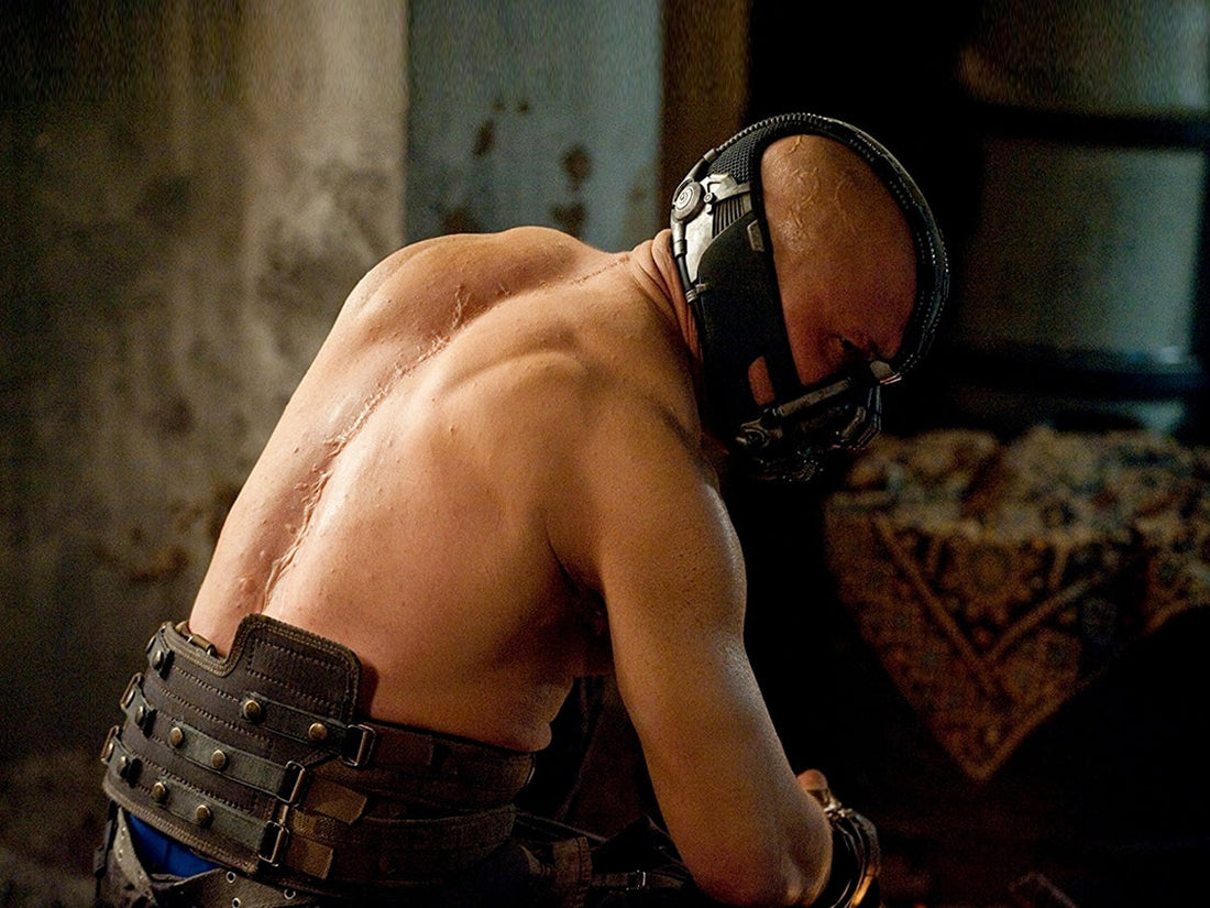 Bane-inspired thick upper-body physique with massive traps and shoulders
