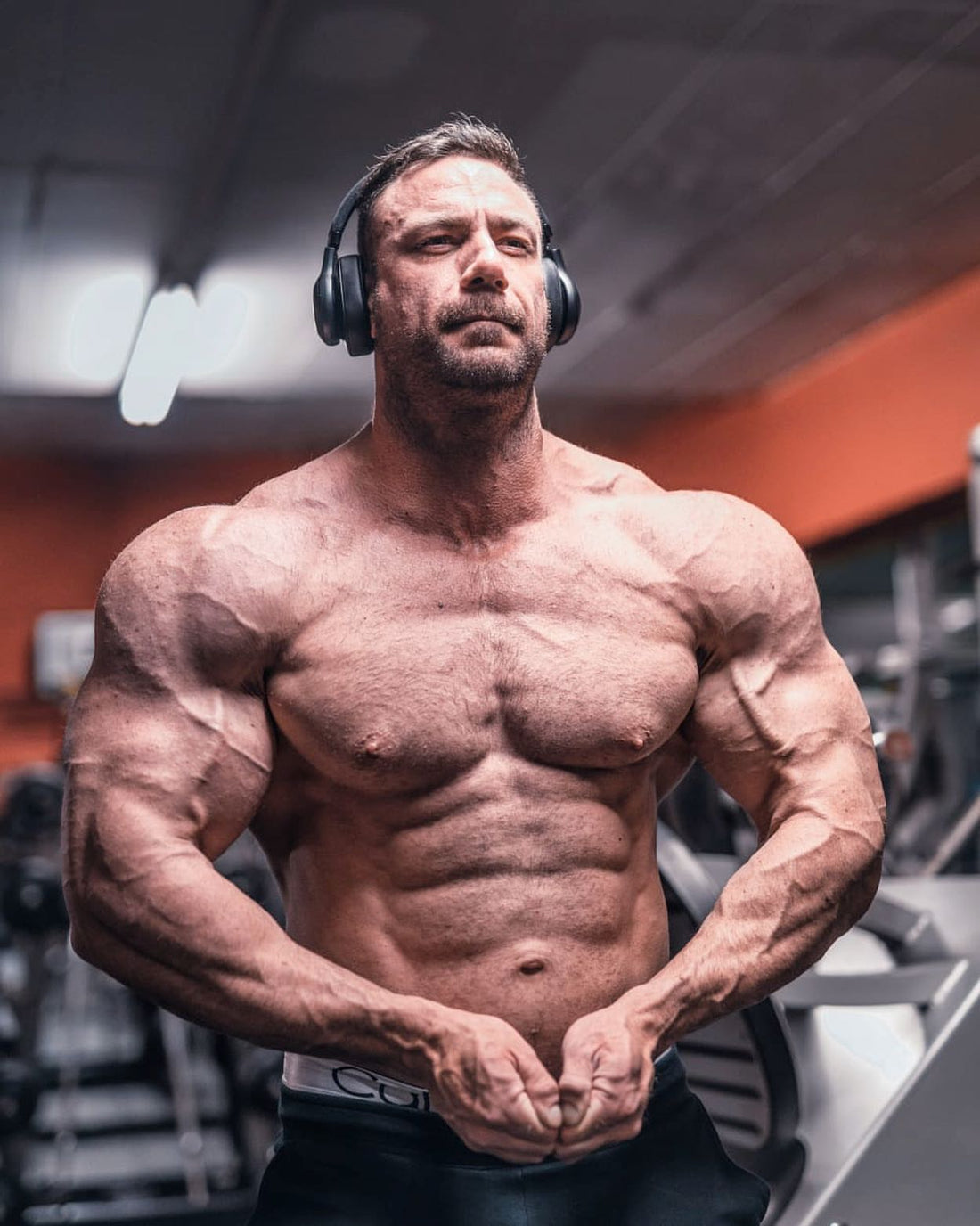 Noel Deyzel in a gym, representing the Daddy Noel bodybuilding humor and advice persona