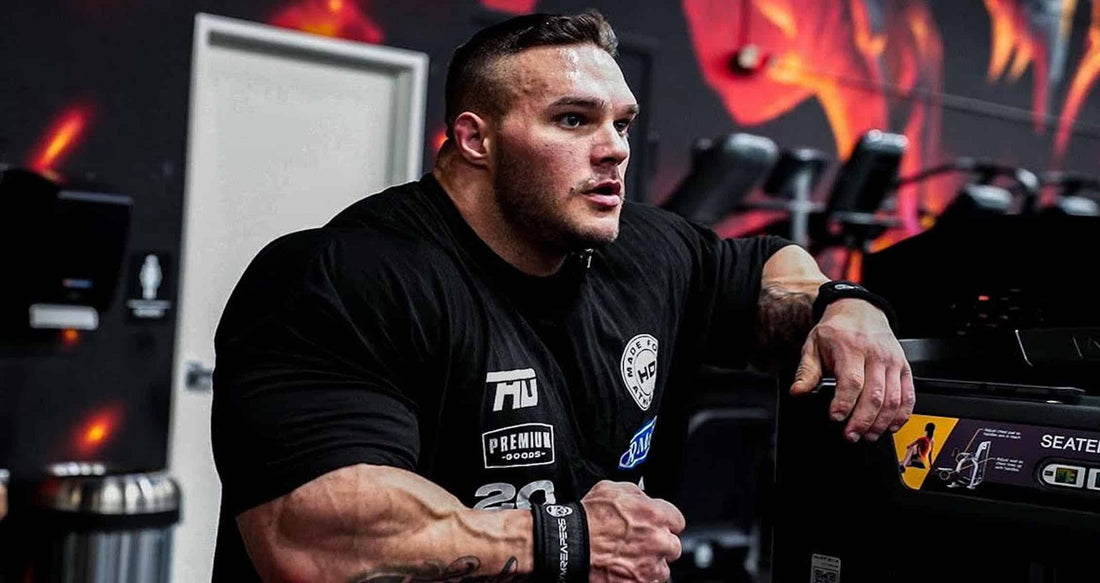 Nick Walker posing in a muscular most-muscular stance at the 2026 Arnold Classic under blue stage lights