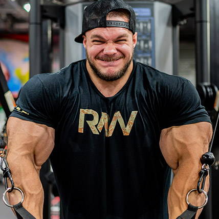 Nick Walker performing a cable chest fly in the gym, demonstrating chest-focused training behind his post-Olympia refinement.