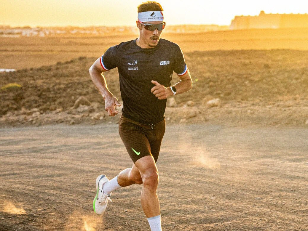Vincent Luis running in a black racing kit at an earlier triathlon event