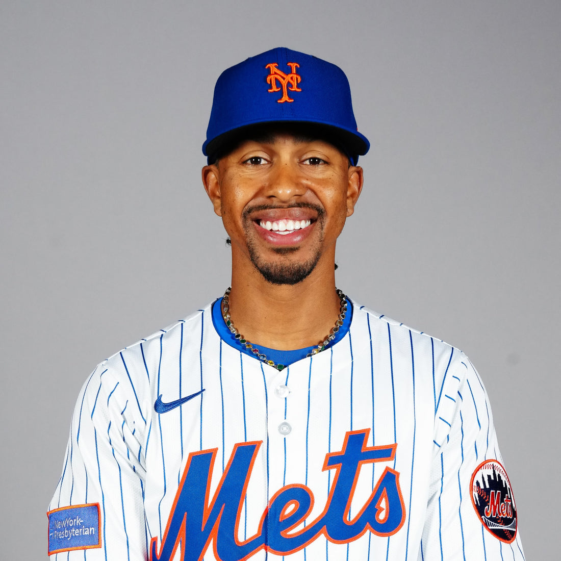 Francisco Lindor smiles in a New York Mets uniform and cap