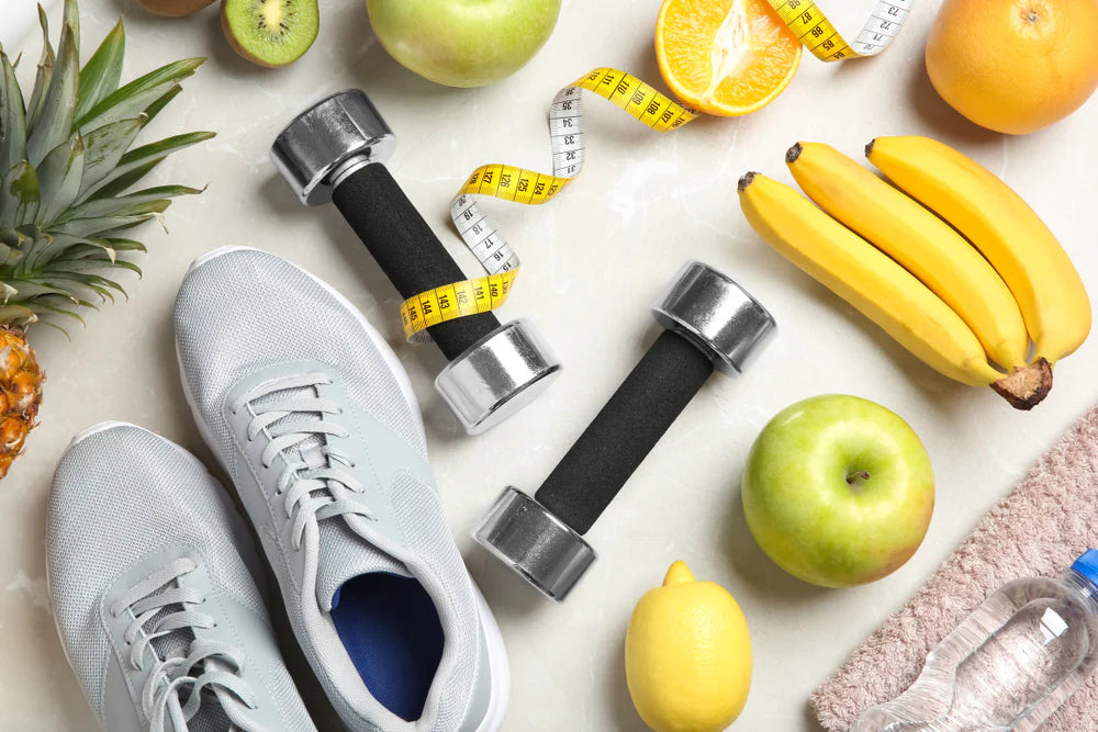 Running shoes, dumbbells, measuring tape and fresh fruit representing a balanced fitness plan
